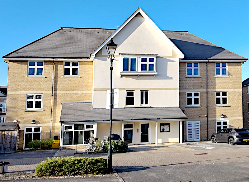 The building on Clearwater Place that includes the Waterways Community Room - showing the front door and the notice board